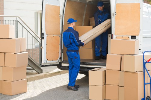 Removal team planning a safe move with equipment and protective packing