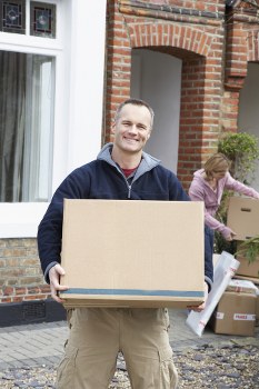 Removalists handling a house move in Barnes with boxes and furniture
