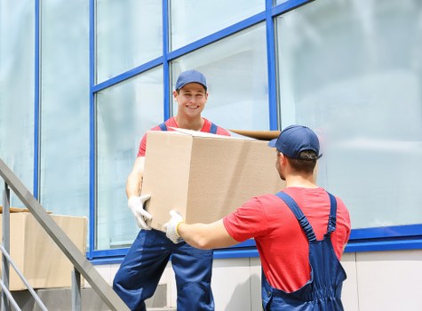 Trained movers handling furniture carefully during a house removal