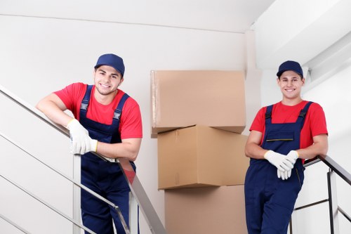 Packing boxes and wrapping household items for a move in Barnes