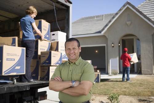 Professional movers handling boxes and furniture in Barnes