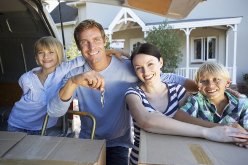 Family planning a home move in Barnes with boxes and moving checklist